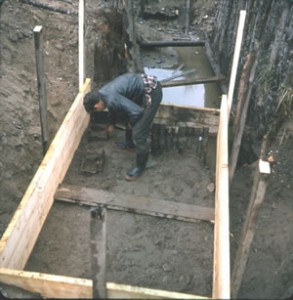 Bobby inspecting the remains of wooden boxes uncovered when they started one of their beach shafts.